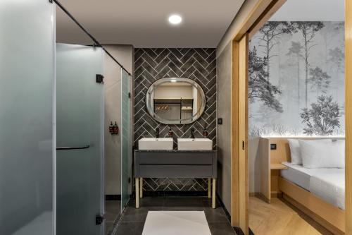 a bathroom with a sink and a mirror at Ginger Chandigarh, Zirakpur in Zirakpur