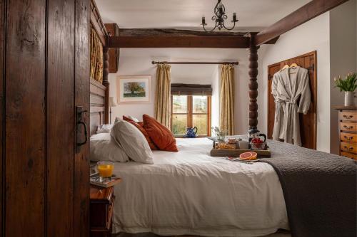 a bedroom with a large bed and a window at Honey Buzzard Farmhouse in Ilfracombe