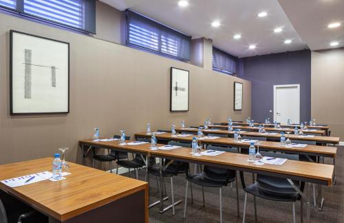 a large room with rows of tables and chairs at Porcel Torneo in Seville