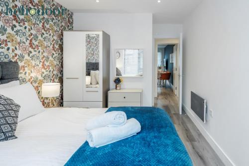 a bedroom with a bed with towels on it at HAL Heliodoor Apartments Milton Keynes, Free Parking, Free WiFi & Movies, 7-min drive to City Centre in Wolverton