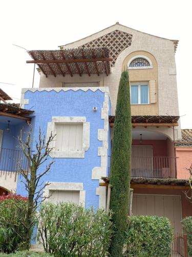a blue house with a tree in front of it at Cascina Jesolana in Lido di Jesolo