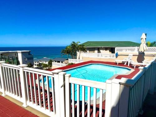 a swimming pool on a balcony with the ocean in the background at Irina House&BreakerView in Ramsgate