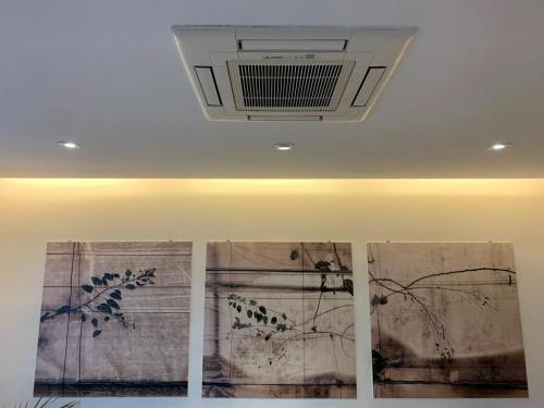 three paintings on the ceiling of a room at Como Lake Crispi 7 Apartment in Como