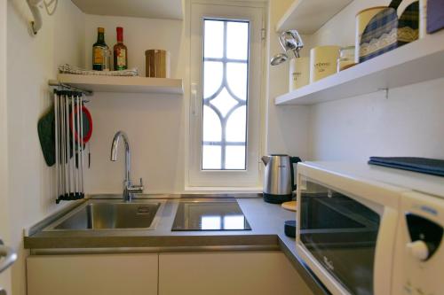a kitchen with a sink and a window at Como Lake Crispi 7 Apartment in Como
