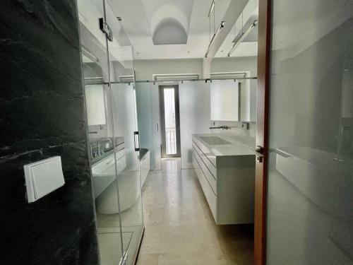 a large white bathroom with a sink and a mirror at Fdez Amazing House by Cathedral and Giralda with private Pool in Seville