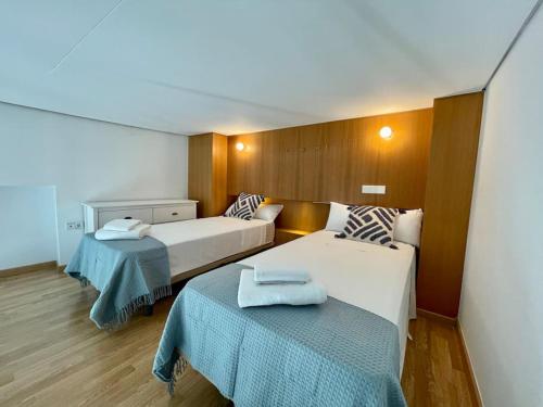 a hotel room with two beds and two tables at Fdez Amazing House by Cathedral and Giralda with private Pool in Seville