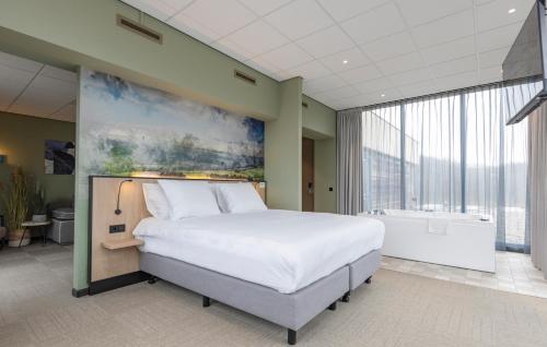 a bedroom with a large bed and a bath tub at Fletcher Hotel-Restaurant Marknesse in Marknesse
