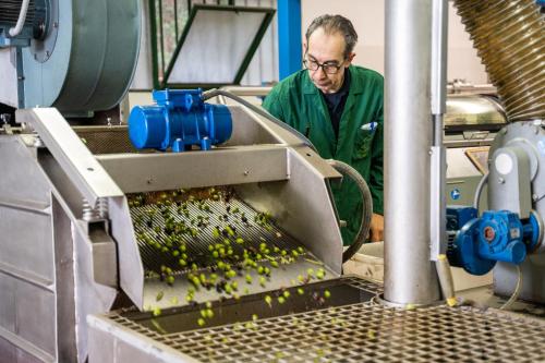 a man in a factory working on a machine at Agriturismo Vecchio Borgo Di Inalbi in Impruneta