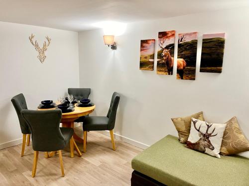 a living room with a table and a dining room at Apartment in Coldstream in Coldstream