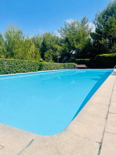 une grande piscine bleue dans une cour dans l'établissement Chez Mathys, à Villeneuve-Loubet