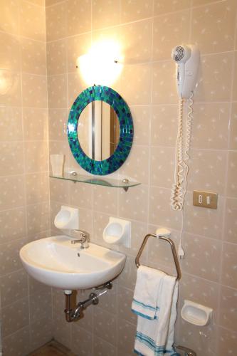 a bathroom with a sink and a phone on the wall at Appartamenti Corneliani in Sirmione