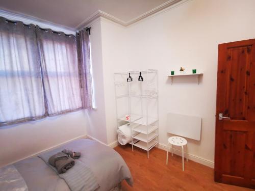 a bedroom with a bed and a book shelf at Center Place - Near Derby City Center in Derby