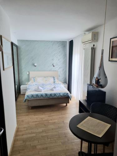 a bedroom with a bed and a couch and a table at Dixy 2 in Belgrade