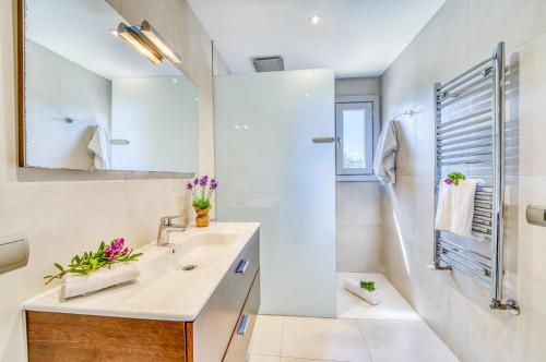 a bathroom with a sink and a mirror at Ideal Property Mallorca - Son Morei Gran in Muro