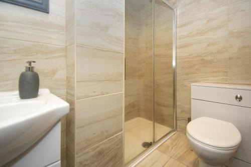 a bathroom with a shower and a toilet and a sink at Paisley Pad: Glasgow Gateway in Paisley
