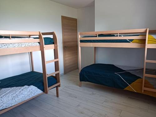 a room with three bunk beds in a room at Villa Côté Ceüze Pelleautier in Pelleautier