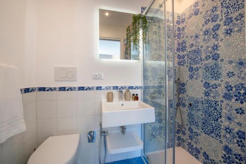 a bathroom with a sink and a shower at Casa Diodora, Costiera Amalfitana in Maiori