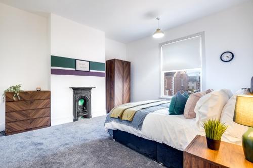 a bedroom with a bed and a fireplace at Lovely Central Loughborough Abode - Games Room in Loughborough