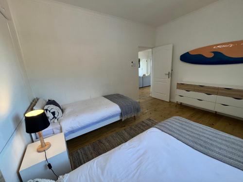 a small bedroom with two beds and a lamp at Casa Mia in Ponta Malongane