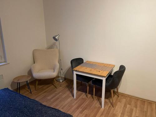 a room with a table and chairs and a lamp at Sunlit apartment close to city center in Prague