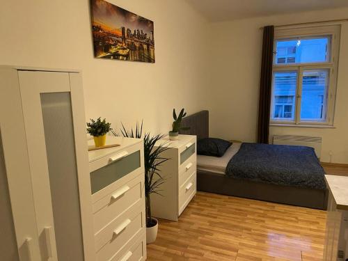 a bedroom with a bed and a dresser at Sunlit apartment close to city center in Prague