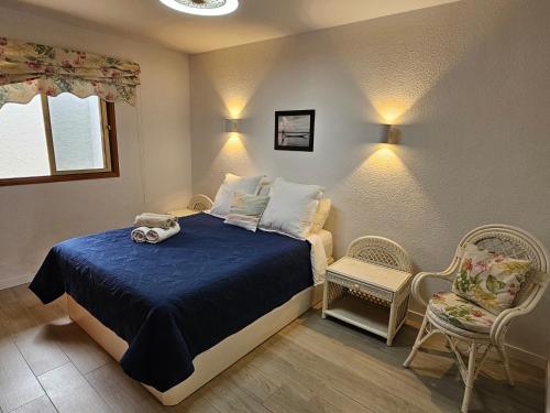 - une petite chambre avec un lit et une chaise dans l'établissement Beautiful Sunset Apartment, à Puerto de Santiago