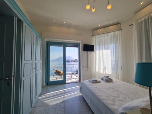 a bedroom with a bed and a view of the ocean at Luxury Villa Olga in Stresa in Baveno