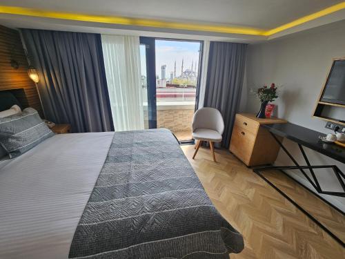 a hotel room with a large bed and a television at Anthemis Hotel in Istanbul