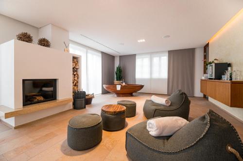 a living room with chairs and a fireplace at Neumühle Resort & Spa in Hammelburg
