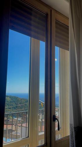 two windows in a hotel room looking out at the ocean at B&B Aria Ona in Villagrande Strisaili