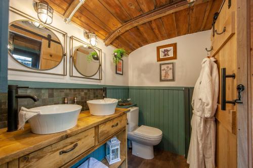 a bathroom with two sinks and a toilet at The Carriage at Creagan in Creagan