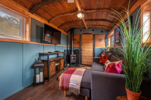 a living room with a couch and a stove at The Carriage at Creagan in Creagan