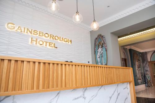 a sign for the entrance to a sinemuri hotel on a wall at Gainsborough Hotel in London