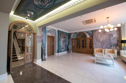 a lobby of a building with paintings on the walls at Gainsborough Hotel in London