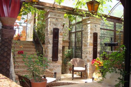 an outside patio with a chair and some plants at Residenza L'Antico Borgo Hotel in Filadelfia