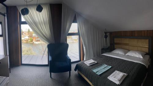 a bedroom with a bed and a large window at Rikabar Restaurant & nature in Bila Tserkva