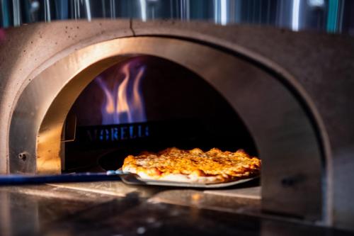 a pizza is coming out of an oven at stays by friends Gelsenkirchen in Gelsenkirchen