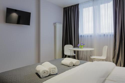 a hotel room with a bed and a table with chairs at Studio VIKTORY 5 В, 21 floor, Kyiv in Kyiv