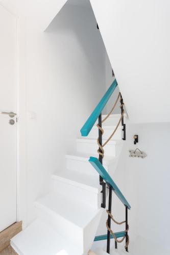 a staircase in a house with blue railings at Chill and sun Alcala By Sunkeyrents in Alcalá