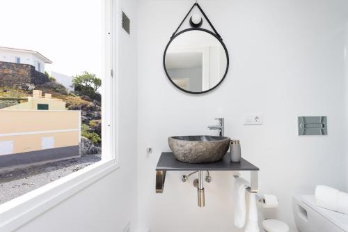 a bathroom with a sink and a mirror at 150 Chill and sun Alcala By Sunkeyrents in Alcalá