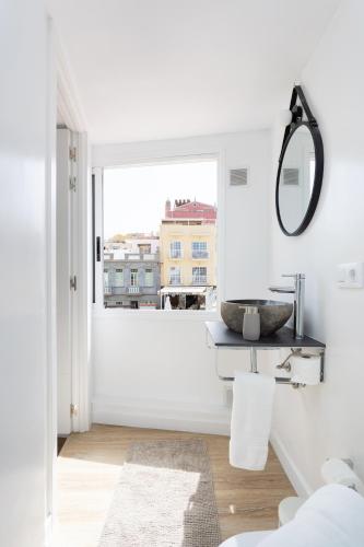 a bathroom with a sink and a mirror at Chill and sun Alcala By Sunkeyrents in Alcalá