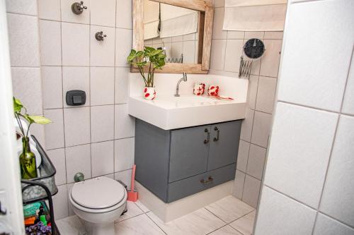 a small bathroom with a sink and a toilet at Apto de frente para a praia Jose Menino Santos SP in Santos