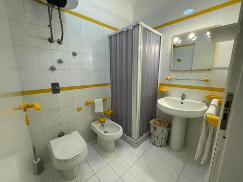 a bathroom with a toilet and a sink and a shower at Appartamento Girasole in San Vito lo Capo