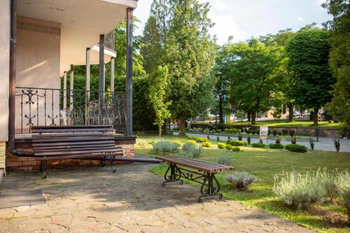 a park with a bench and a gazebo at Hotel Sani in Truskavets
