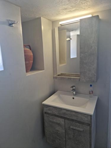 a bathroom with a sink and a mirror at Amazing View Dream House in Chora Folegandros