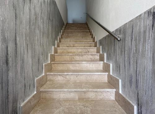 a staircase in a building with a concrete wall at LXR Rooms Carloforte in Carloforte