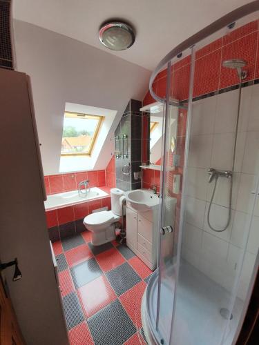 a bathroom with a toilet and a sink and a shower at Apartmán v blízkosti města Štětí in Štětí