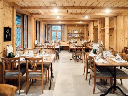 a dining room with wooden tables and chairs at Gasthaus Hof in Appenzell