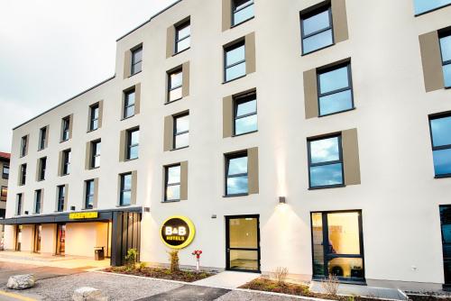 a white building with black windows at B&B Hotel Kempten in Kempten