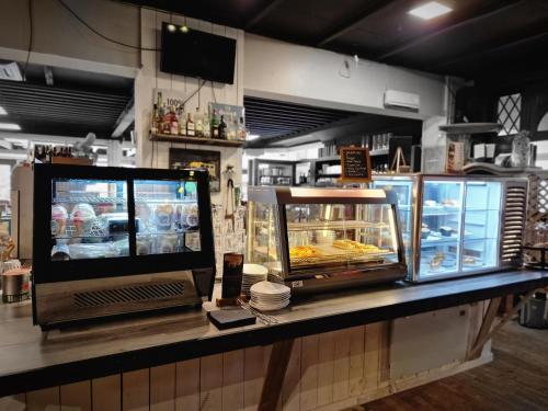 a counter in a bakery with a display case at Hof van Sellingen in Sellingen